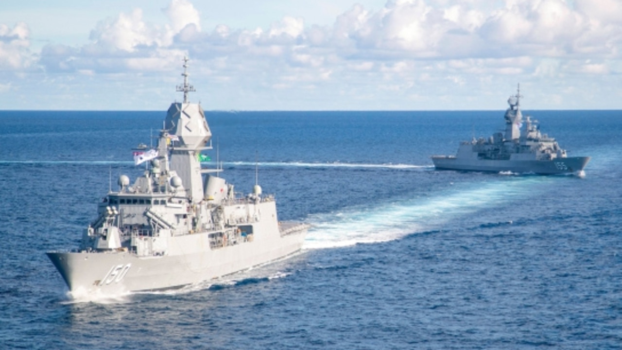 HMAS Ballarat crosses HMAS Anzac's wake as they sail in close quarters in the Natuna Sea.