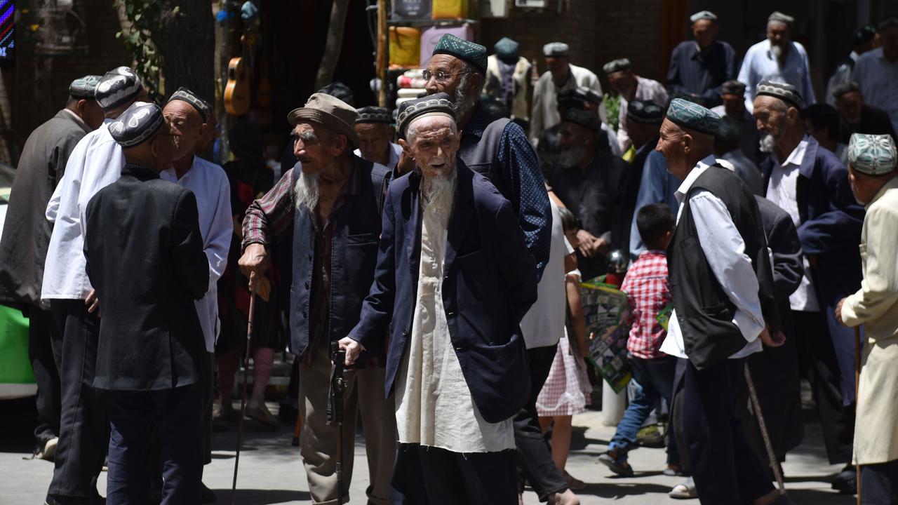 Uyghur men leave a mosque in Hotan. Picture: Greg Baker/AFP