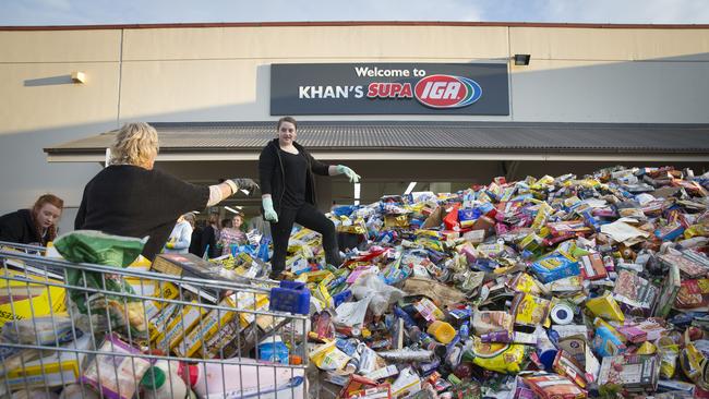 IGA employee Emma Duff, 18, sorts through a huge mountain of rubbish at Picton. Picture: Melvyn Knipe