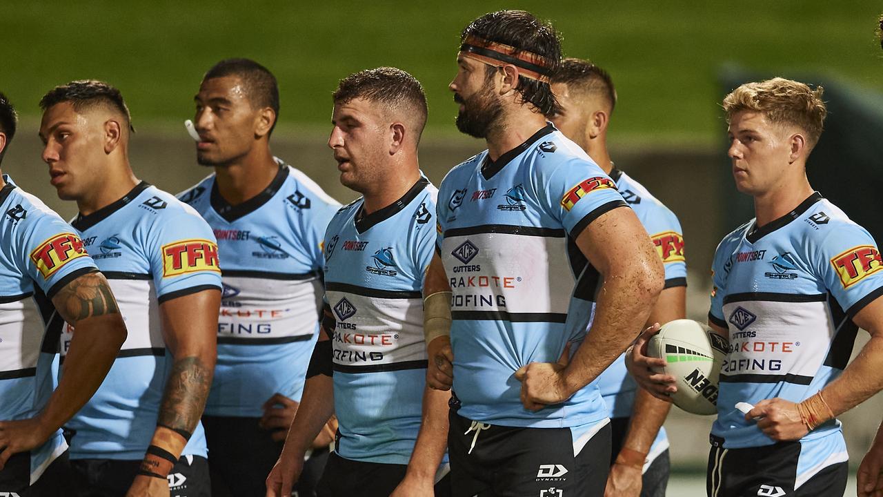 Sharks players show their dejection after a Melbourne try.