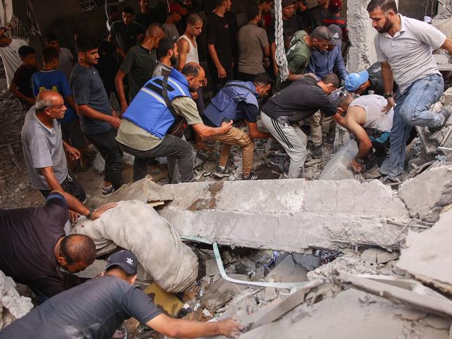 People sift through debris after a school used as shelter by displaced Palestinians was hit by an Israeli strike in the Shujaiya neighbourhood of Gaza City. Picture: AFP