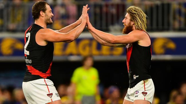 Tom Bellchambers and Dyson Heppell celebrate a goal.