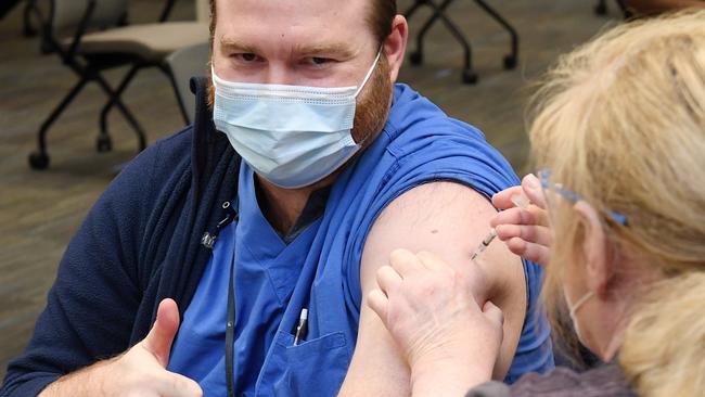 Dr Keaton Nasser gives a thumbs-up as he receives a Pfizer-BioNTech COVID-19 vaccination in Las Vegas, Nevada, on Wednesday. Picture: AFP