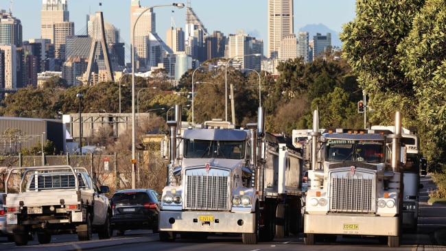 Dozens of trucks stopped in a convey across two of Sydney's major bridges, honking their horns to bring attention to whether transport workers are affected by the latest COVID-19 restrictions. Picture: David Swift/NCA