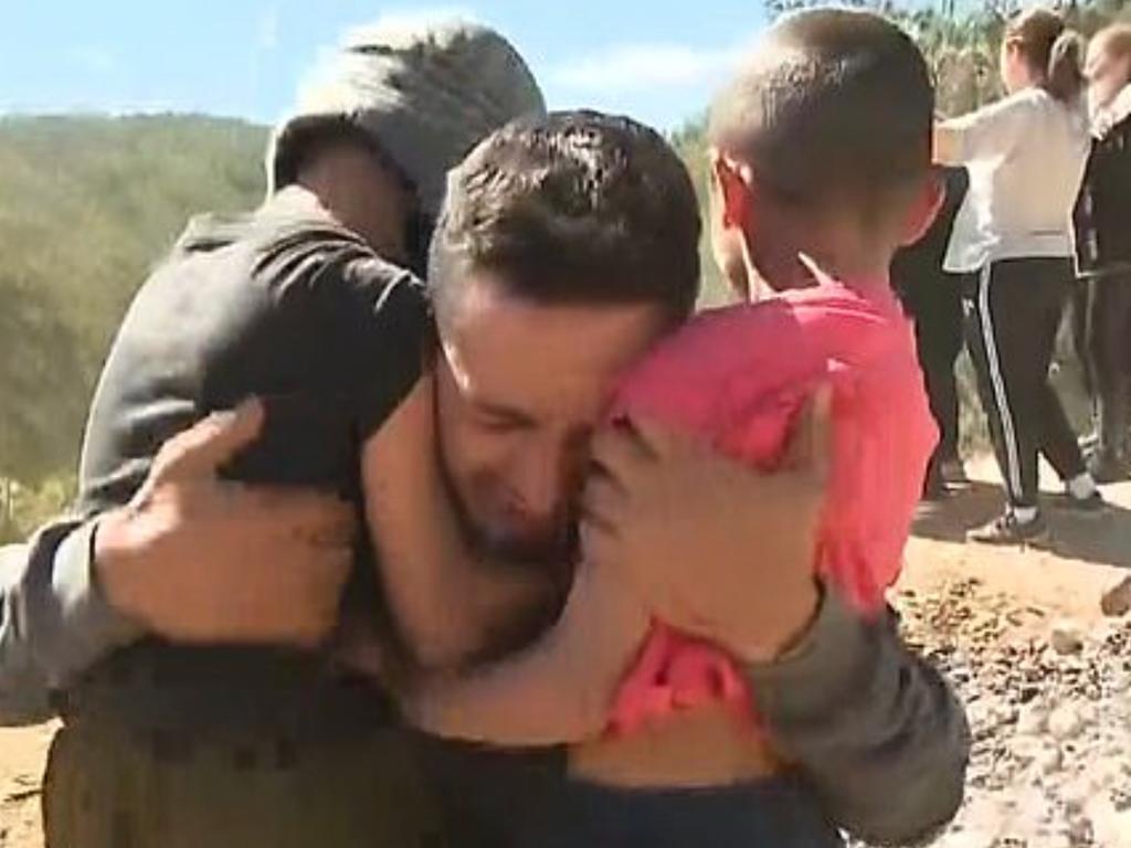 AJ's father hugging his other two children after hearing his son had been found. Picture: 9 News