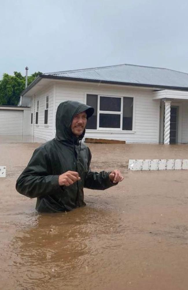 Mrs Smith and Mr Nicholls waded through flood waters outside their newly renovated home. Photo: Sophie Smith.