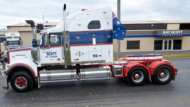 Mr Scott’s coffin on the back of the back of one of his comany’s trucks as it passes the Scott company headquarters. Picture Frank Monger