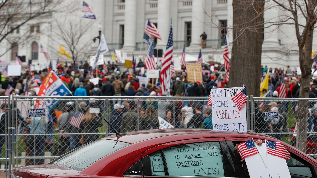 A car with placards damning the coronavirus shutdown in Madison, Wisconsin on Friday. Picture: Kamil Krzaczynski