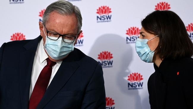 NSW Health Minister Brad Hazzard, left, speaks to Premier Gladys Berejiklian in Sydney on Monday. Picture: Bianca De Marchi