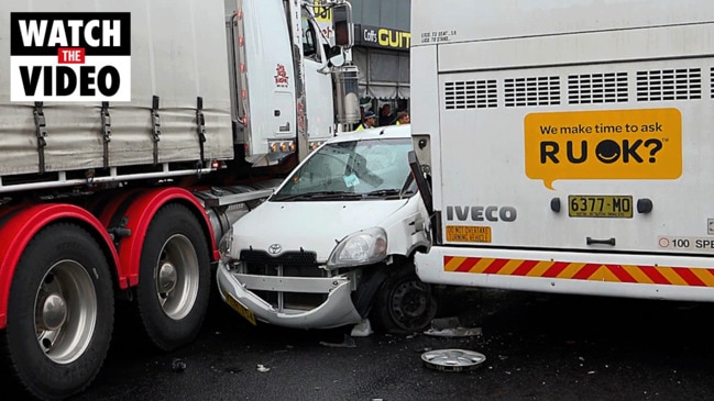 Car wedged between truck and bus in Coffs Harbour CBD