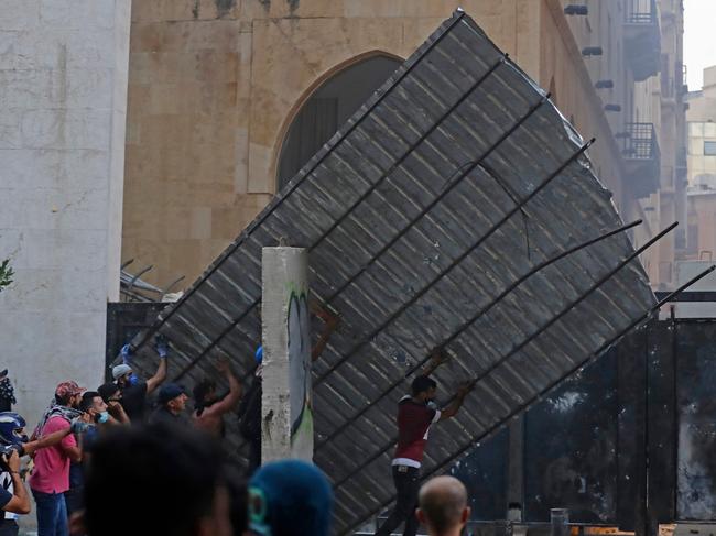 Protesters try to force a gate open near parliament in central Beirut. Picture: AFP