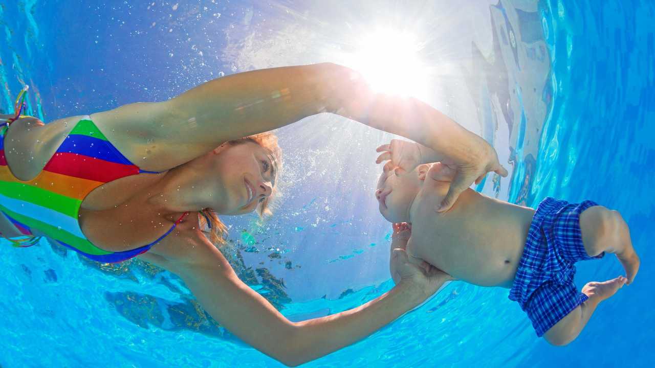 Mother teaches her baby son to swim and dive. Picture: Denis Moskvinov