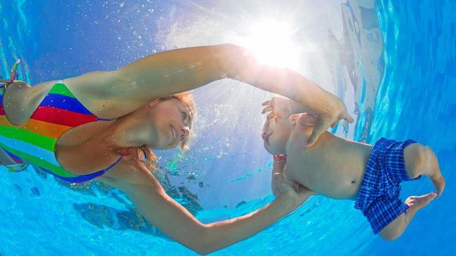 Mother teaches her baby son to swim and dive. Picture: Denis Moskvinov