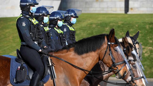 Police on horseback patrol the Shrine of Remembrance enforcing the wearing of face masks in Melbourne on July 31. Picture: William West/AFP