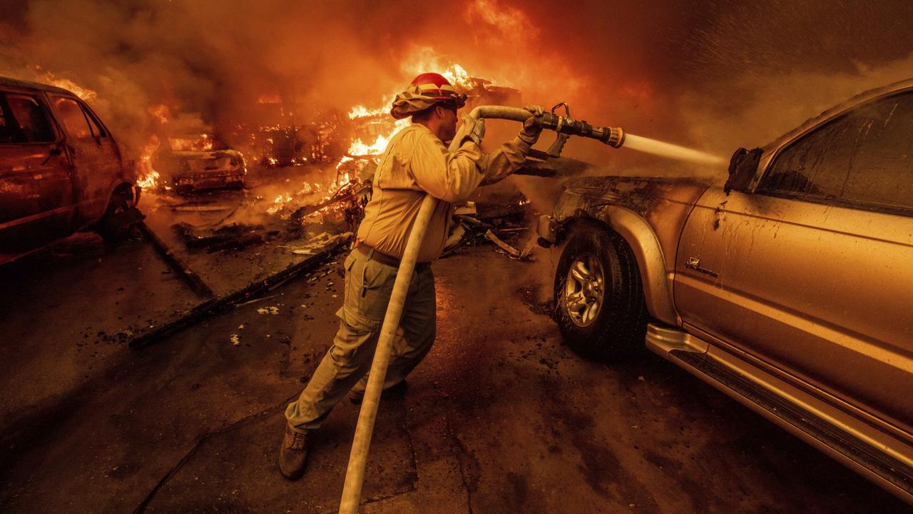 A firefighter battles the Eaton Fire. Picture: AP Photo/Ethan Swope