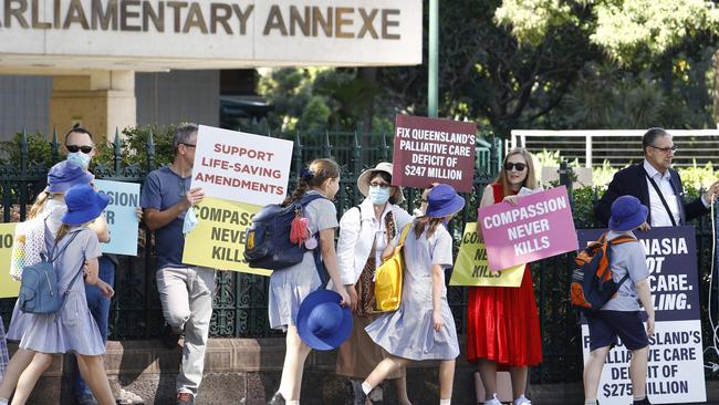 School children walk past a small group of anti-VAD protestors gathered at parliament ahead of the QLD euthanasia debate in Brisbane. Picture: NCA NewsWire/Tertius Pickard