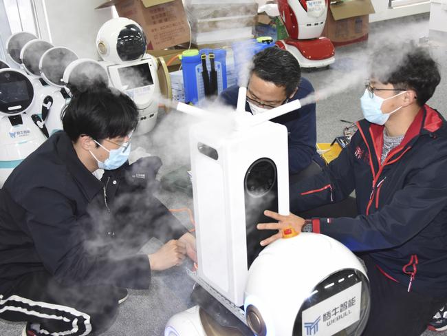 Technicians work on a second generation disinfection robot, which can replace human in disinfection operations for possible use in isolation wards of hospitals, in Qingdao, eastern China's Shandong Province. Picture: Li Ziheng/Xinhua via AP