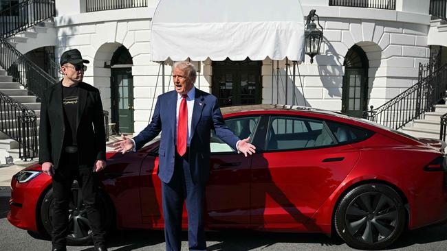 US President Donald Trump spruiking Tesla earlier this month in a show of support to Elon Musk. Picture: AFP