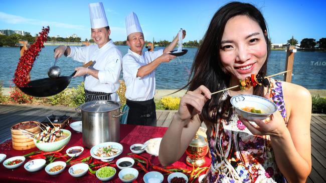 Chef's Jin Dai and Tiezheng cook up a feast while Lijia Gao digs in. Picture Rebecca Michael.