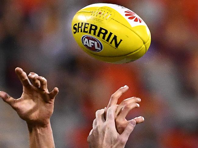 Generic picture of hands competing for the ball during the round 5 AFL match between the Gold Coast Suns and the North Melbourne Kangaroos at Metricon Stadium on the Gold Coast, Saturday, April 23, 2016. (AAP Image/Dave Hunt) NO ARCHIVING, EDITORIAL USE ONLY