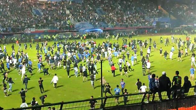 At least 127 people, including two police officers, have been killed in a stampede triggered by the use of tear gas to quell unrest after an Indonesian league football match in East Java on Sunday.