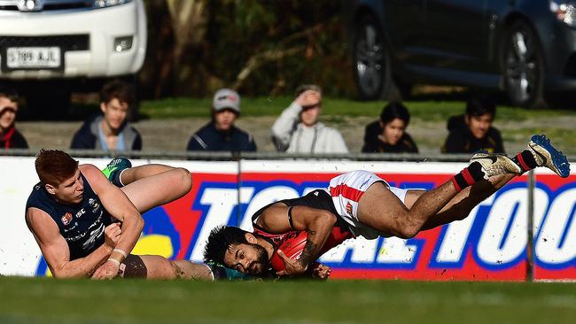 It wasn’t easy to keep the Bloods down. West’s Zac Bates takes a diving mark in front of South's Joseph Haines. Picture: Tom Huntley