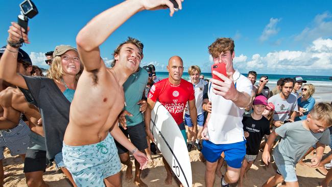 Kelly Slater is mobbed by fans after his round 3 loss at the Sydney Surf Pro on Thursday. Picture: AAP 