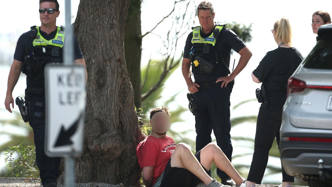 Police arrest a man at the scene above Eastern Beach. Picture: David Smith