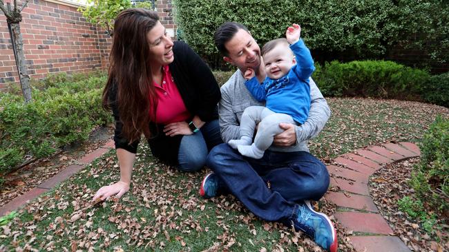 Michelle Jacobs and Dean Davis with their 10-month-old son at home in Caulfield. Mr Davis has lost his job. Picture: David Geraghty