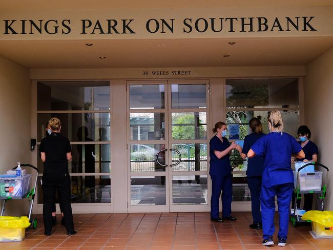 Health workers arrive to check on tenants of the townhouse complex. Picture: NCA NewsWire / Luis Ascui