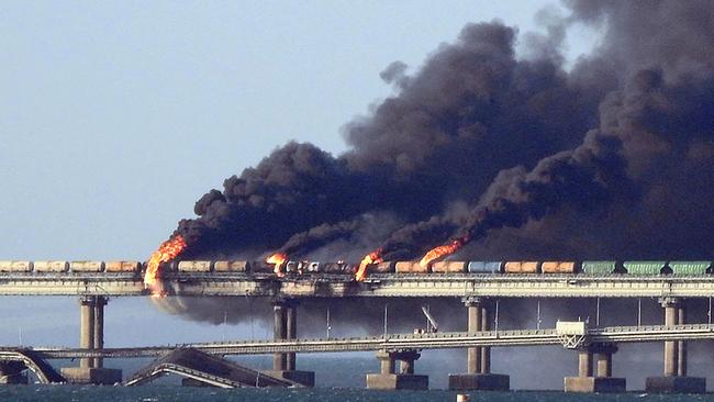 Black smoke billows from a fire on the Kerch bridge that links Crimea to Russia, after a truck exploded, near Kerch, on October 8, 2022. Picture: AFP.