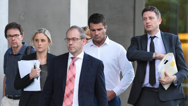 Gable Tostee leaves the Supreme Court in Brisbane with his legal representatives. Picture: AAP Image/Dave Hunt