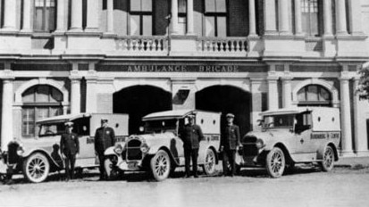 Bundaberg Ambulance Brigade, 1925. Ambulance personnel and upgraded vehicles outside their new station in Bundaberg. Source: State Library of Queensland