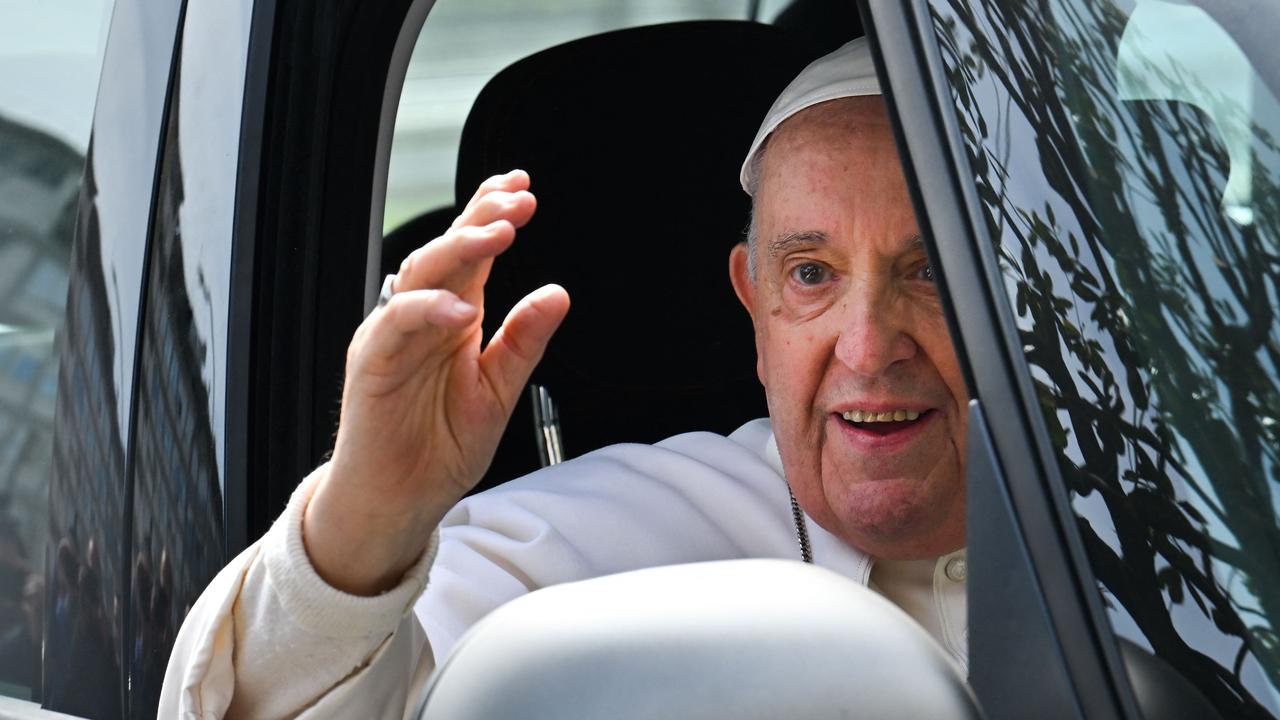 Pope Francis waves as he leaves the Gemelli hospital. Picture: AFP