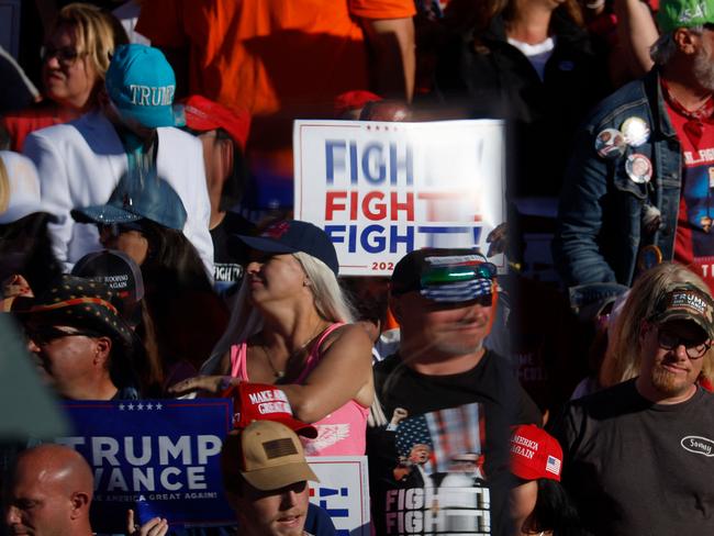 Supporters are distorted by bullet resistant glass while attending Donald Trump’s campaign rally at the Butler Farm Show grounds. Picture: Getty Images via AFP