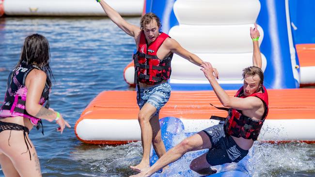 Lane Cole-Delu, Seymour Butte and Charlie Moir tackle the Melbourne Cable Park water playground and obstacle course. Picture: Jason Edwards