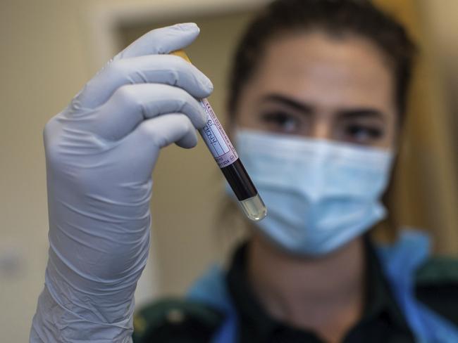 Paramedic Jess Baddams holds a blood sample in Birmingham, England.