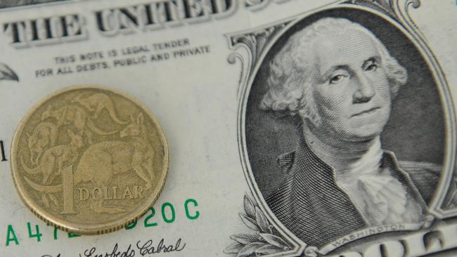 A 1 Australian Dollar coin and a 1 US Dollar note are seen in Canberra, Tuesday, May 21, 2013. As the US economy rebounds, there are predictions that the Australian dollar could fall as low as 90 US cents in the coming weeks and months. (AAP Image/Lukas Coch) NO ARCHIVING