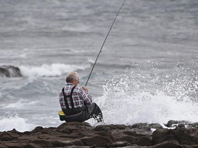 Gary Cuzner who has been fishing at Hill 60 Near Fishermans Beach for over 50 years on an area he considers to be safe at Hill 60 on the 13th of February. Two men are dead after being swept off rocks at Port Kembla's Hill 60 Near Fishermans Beach. Picture: Adam Yip