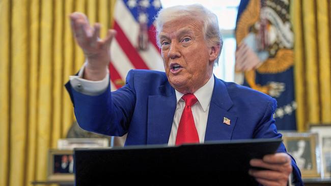 Donald Trump speaks to the media as he signs more executive orders in the Oval Office on Thursday. Picture: AP