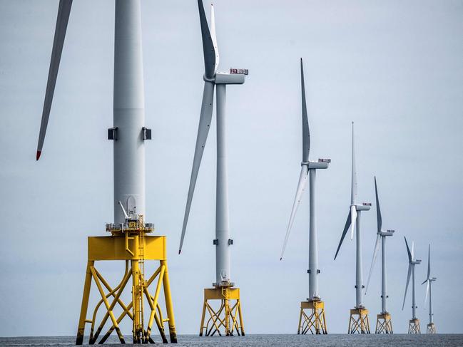 (FILES) A photograph taken on June 8, 2023 shows wind turbines at the Seagreen Offshore Wind Farm, under construction around 27km from the coast of Montrose, Angus in the North Sea. The British energy regulator Ofgem on Friday lowered the ceiling corresponding to the price paid by a majority of Britons for electricity and gas, to its lowest level since the start of the war in Ukraine, which caused bills to soar. (Photo by Andy Buchanan / AFP)