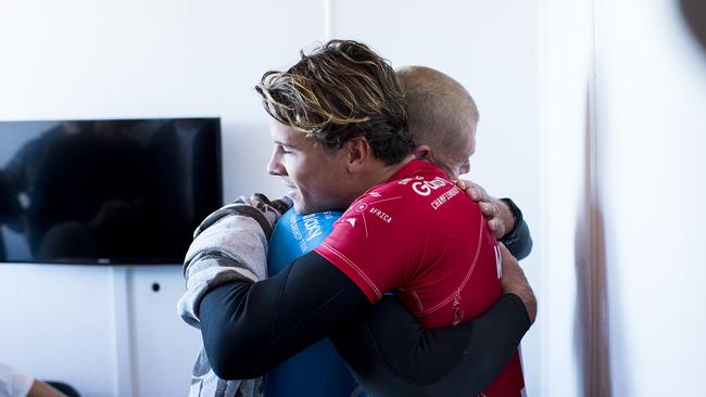 Julian Wilson hugs Mick Fanning (Blue) from the safety of shore after Fanning was attacked by a shark during the FInal of the JBay Open on Sunday July 19, 2015. Pic: Kirstin Scholtz / World Surf League