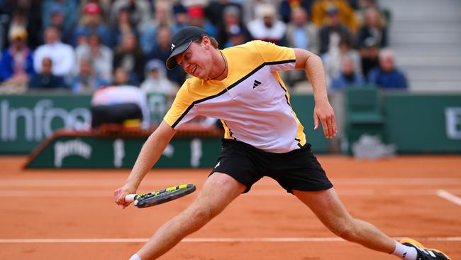 Alex Michelsen of United States plays a backhand against Alex De Minaur of Australia in the Men's Singles first round match on Day Three of the 2024 French Open at Roland Garros on May 28, 2024 in Paris, France. (Photo by Clive Mason/Getty Images)