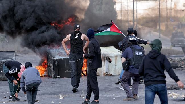 Palestinians take Israeli soldiers on with stones in Ramallah. Picture: AFP