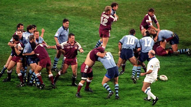 Linesman Martin Weekes (right) runs on to field as all-in brawl erupts during the 1995 State of Origin match at the MCG. Photo: File