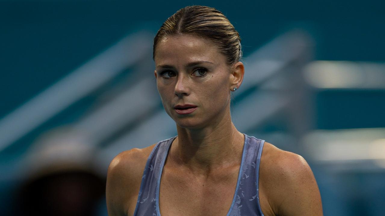 MIAMI GARDENS, FLORIDA - MARCH 23: Camila Giorgi of Italy walks to get her towel against Iga Swiatek of Poland during their match at Hard Rock Stadium on March 23, 2024 in Miami Gardens, Florida. (Photo by Brennan Asplen/Getty Images)