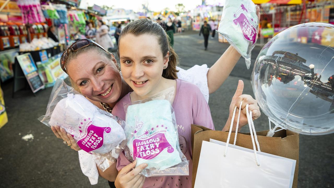 Amanda Smith and daughter April Coles with fairy floss from sideshow alley at the Toowoomba Royal Show, Thursday, March 30, 2023. Picture: Kevin Farmer