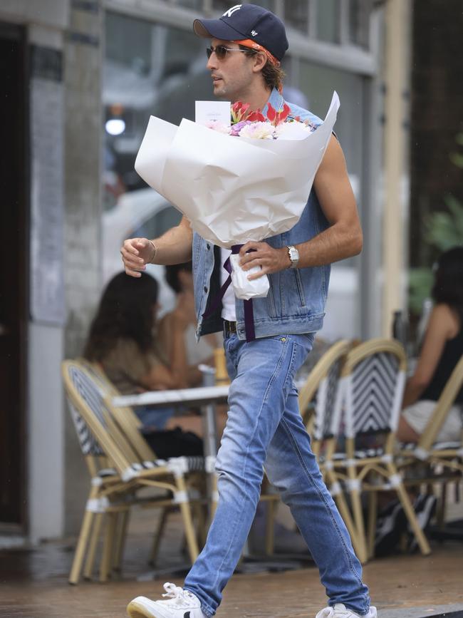 A partygoer arriving with flowers for Francesca Packer-Barham’s 30th Birthday. Picture; Media Mode