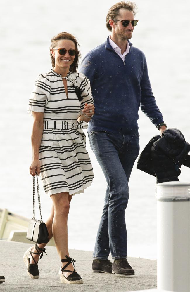 A little windswept but all smiles, Pippa Middleton and her new husband James Matthews on their return to Sydney. Picture: Justin Lloyd