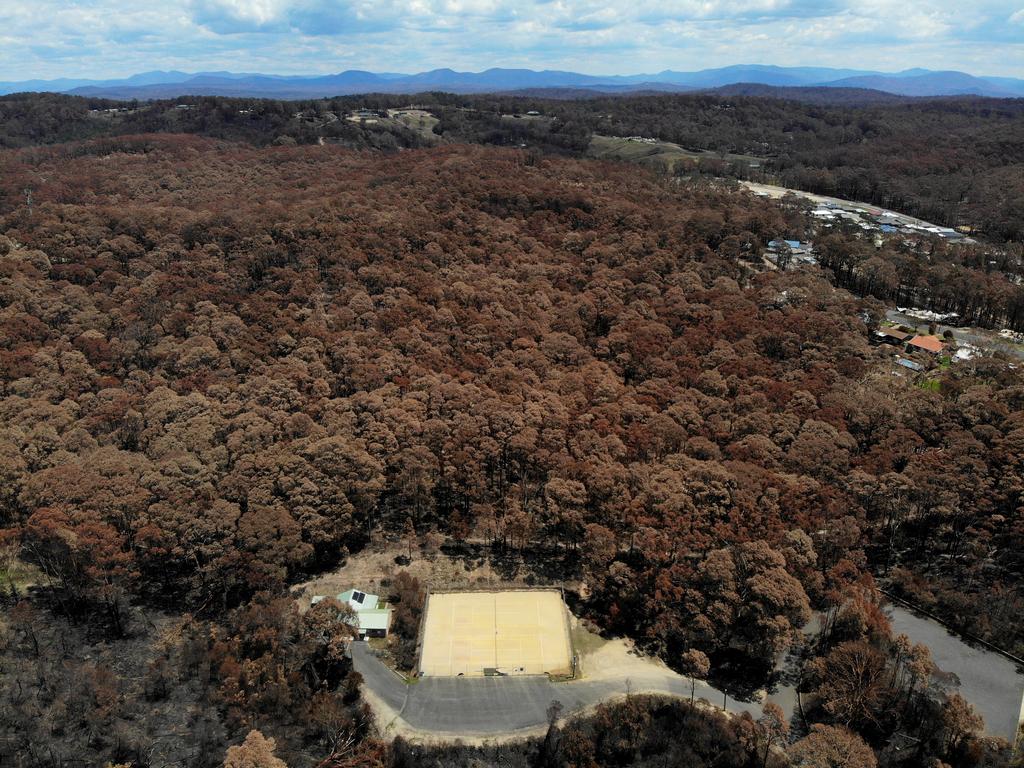 Homes in Malua Bay were randomly destroyed by the New Years Eve fire storm while others were left virtually untouched. The bush behind the tennis club was completely burnt out while the tennis courts and club house themselves survived. Picture: Toby Zerna